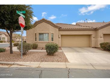 Charming single-story home featuring a two-car garage, low maintenance landscaping, and neutral color palette at 1589 E Manor Dr, Casa Grande, AZ 85122