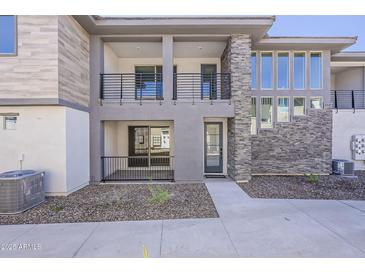 Contemporary home with multiple balconies, modern stone accents, and manicured landscaping offering curb appeal at 2121 W Sonoran Desert Dr # 45, Phoenix, AZ 85085