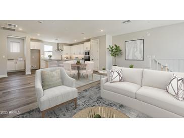 Open concept living space features a modern kitchen, dining area, and hardwood floors with lots of natural light at 2121 W Sonoran Desert Dr # 45, Phoenix, AZ 85085