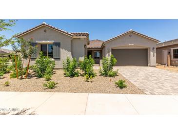 Charming single-story home with desert landscaping and a paver driveway leading to the garage at 21640 E Roundup Way, Queen Creek, AZ 85142