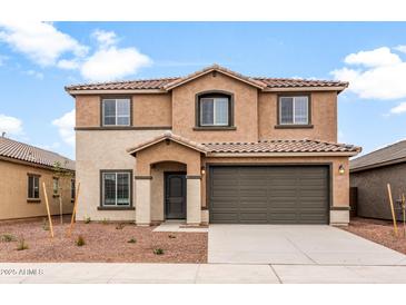 Charming two-story home with neutral stucco, tile roof, well-kept landscaping, and an attached two-car garage at 25248 W Chanute Pass, Buckeye, AZ 85326