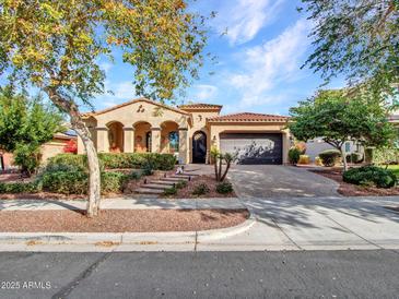 Charming single-story home featuring desert landscaping and a two-car garage at 2957 N Riley Ct, Buckeye, AZ 85396