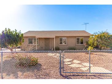 Charming single-story home with desert landscaping, fenced yard and a welcoming front entrance at 848 N Main Dr, Apache Junction, AZ 85120