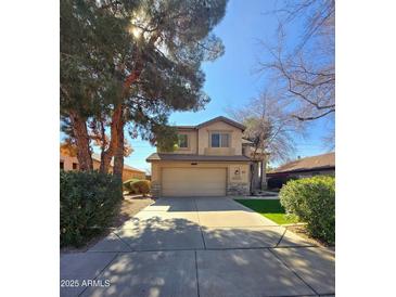 Charming two-story home featuring a well-manicured lawn and an attached two-car garage at 1043 W Washington Ave, Gilbert, AZ 85233