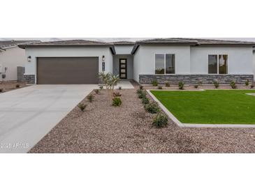 Beautiful single-story home featuring a low maintenance yard with rock landscaping and a covered two car garage at 11206 E Crescent Ave, Mesa, AZ 85208