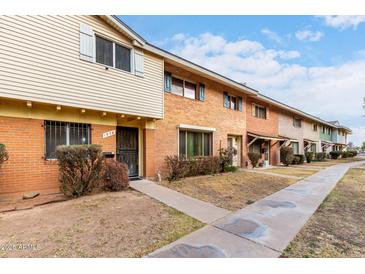 A row of quaint townhomes showcases a well-maintained exterior with brick and siding details at 1578 W Campbell Ave, Phoenix, AZ 85015