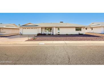 Charming single-story home with a two-car garage, desert landscaping, and well-maintained exterior in a peaceful neighborhood at 18002 N 135Th Dr, Sun City West, AZ 85375