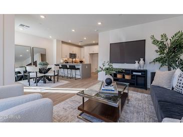 Bright, open-concept living space with modern furnishings and wood-style flooring at 2121 W Sonoran Desert Dr # 41, Phoenix, AZ 85085