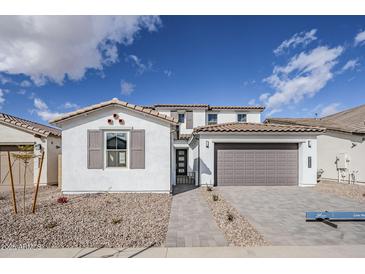 Charming two-story home featuring a symmetrical facade, a two car garage and desert landscaping at 21250 E Sparrow Dr, Queen Creek, AZ 85142