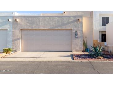 A well-maintained two-car garage features a sturdy door and convenient driveway in front at 2331 E Evans Dr, Phoenix, AZ 85022