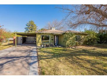 Charming single-story home featuring a spacious front yard and covered carport at 3027 N 21St Pl, Phoenix, AZ 85016