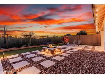 An outdoor fire pit area with desert views and modern landscaping, perfect for entertaining at 30816 N 138Th Ave, Peoria, AZ 85383