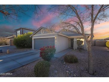 Charming single-story home featuring a well-maintained front yard and attached two-car garage at 34734 N Happy Jack Dr, San Tan Valley, AZ 85144