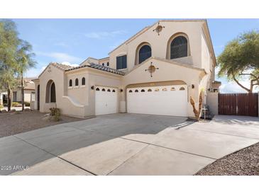 Beige stucco home features three-car garage and archways at 3557 S Halsted Ct, Chandler, AZ 85286