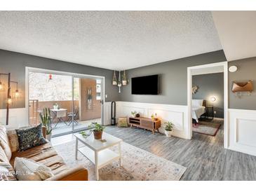 Inviting living room with modern decor, stylish furniture, and sliding glass doors leading to a private balcony at 540 N May -- # 2151, Mesa, AZ 85201