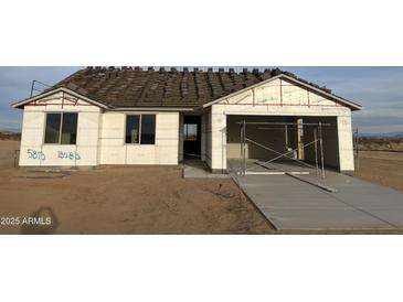 New home under construction showing the framing, windows, garage and new driveway at 5893 N Nigal Rd, Casa Grande, AZ 85194