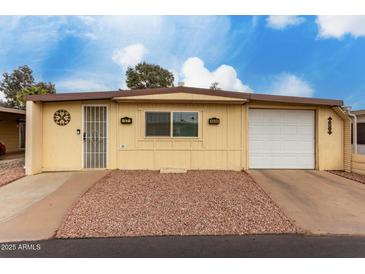 Charming single-story home with attached garage, desert landscaping, and security door at 6830 W Mckinley St, Phoenix, AZ 85043