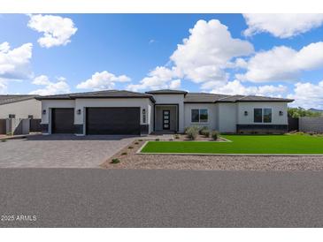 Beautiful home featuring a three car garage, low maintenance landscaping, and a paver driveway at 9230 E Cloudview Ave, Gold Canyon, AZ 85118