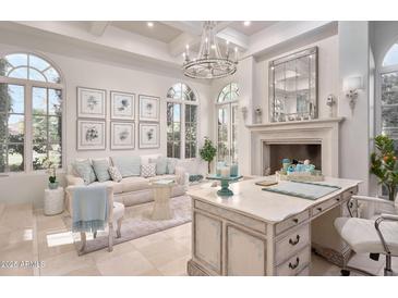 A sunlit office features a fireplace, decorative mirror, custom cabinetry, and coordinated decor for a refined atmosphere at 9547 N 55Th St, Paradise Valley, AZ 85253