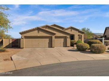 Charming single-story home featuring a three-car garage, desert landscaping, and a tile roof at 13121 S 178Th Ave, Goodyear, AZ 85338