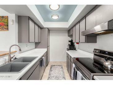 Well-lit kitchen with stainless steel appliances and skylight for a modern feel at 13204 N 3Rd Way, Phoenix, AZ 85022