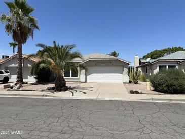 Charming single-story home featuring desert landscaping and a two-car garage at 2634 N Saffron Cir, Mesa, AZ 85215