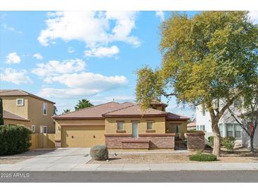 Charming single-story home featuring stone accents, a neutral color palette and a well-manicured front yard at 4284 N 154Th Ave, Goodyear, AZ 85395