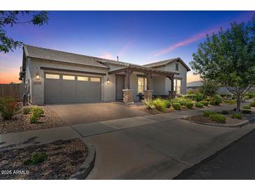 Charming single-Gathering home with a well-manicured front yard and a two-car garage at sunset at 4330 S Neutron --, Mesa, AZ 85212