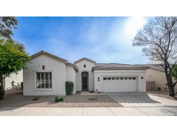 Charming single-story home with a well-maintained front yard and a two-car garage at 4831 E Annette Dr, Scottsdale, AZ 85254