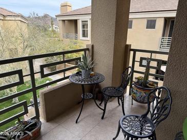 The patio has a decorative table, chairs, and potted plants creating a relaxing outdoor space at 7887 N 16Th St # 227, Phoenix, AZ 85020