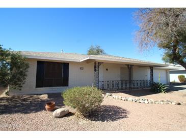 Charming single-story home with a front porch and well-maintained desert landscaping at 9231 W Elkhorn Dr, Sun City, AZ 85351