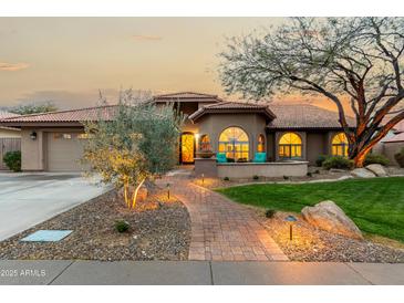 Charming home with a beautifully landscaped yard and inviting entrance at 10105 E Larkspur Dr, Scottsdale, AZ 85260