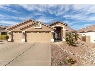 Charming single-story home featuring a three-car garage and low-maintenance desert landscaping at 13804 W Marshall Ave, Litchfield Park, AZ 85340