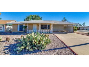 Charming single-story home with well-maintained landscaping and a covered parking area at 14201 N 103Rd Ave, Sun City, AZ 85351