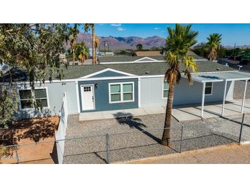 Exterior view of a home featuring a well-maintained yard and mature trees at 1426 E 19Th Ave, Apache Junction, AZ 85119