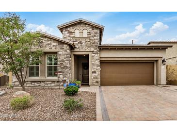 Charming stone-clad home featuring a paver driveway and well-maintained, drought-resistant landscaping at 1752 N Harper --, Mesa, AZ 85207