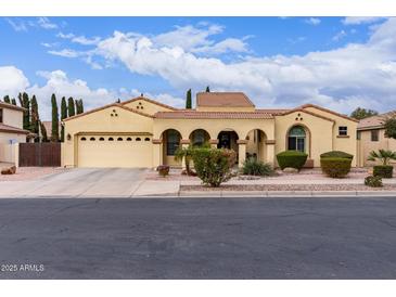 Charming single-story home featuring an arched entryway, desert landscaping, and a two-car garage at 21842 E Via De Olivos --, Queen Creek, AZ 85142