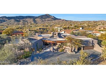 Stunning desert home featuring mountain views, unique architecture, and beautiful landscaping at 40915 N 107Th Pl, Scottsdale, AZ 85262