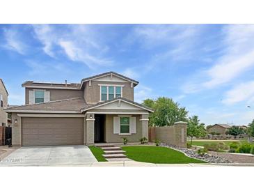 Charming two-story home with a well-manicured front yard and attached two-car garage, situated on a sunny lot at 12227 W Prickly Pear Trl, Peoria, AZ 85383