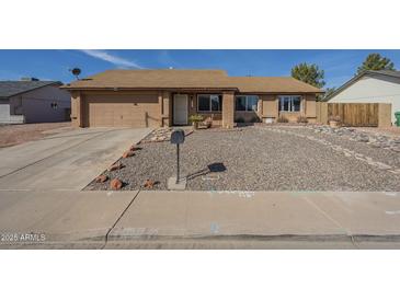 Charming single-story home with low-maintenance desert landscaping and a two-car garage at 1226 N Nevada Way, Mesa, AZ 85203