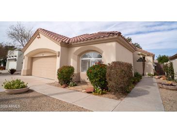 Charming single-story home with a two-car garage and mature landscaping at 14130 W Bent Tree Cir, Litchfield Park, AZ 85340