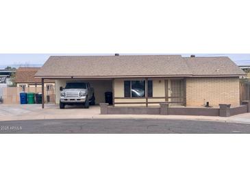 Charming single story home with covered parking and desert landscaping at 1858 N Hibbert Cir, Mesa, AZ 85201