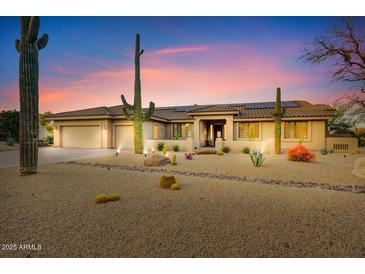 Stunning desert home featuring a spacious layout, beautiful landscaping, and native cacti for an authentic Southwestern feel at 18820 E Gemmill Dr, Rio Verde, AZ 85263