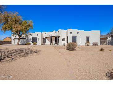 Stunning single-story home featuring a custom adobe design and desert landscaping at 22236 E Nacoma --, Queen Creek, AZ 85142