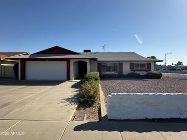 Charming single-story home featuring a two-car garage and desert landscaping at 3849 W Mauna Loa Ln, Phoenix, AZ 85053