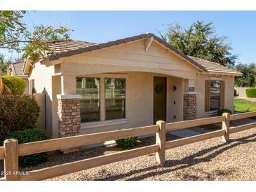 Attractive single-story home with desert landscaping, a welcoming front porch, and charming wood accents at 4428 E Wildhorse Dr, Gilbert, AZ 85297