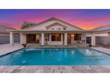 Inviting backyard pool with water feature, covered patio, and beautiful sunset views at 445 W Gary Ave, Gilbert, AZ 85233