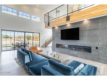 Bright, open living room with a stone accent wall, fireplace and clerestory windows at 8510 S 9Th Dr # 20, Phoenix, AZ 85041