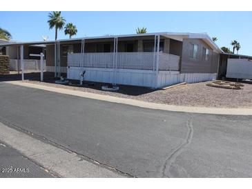Charming single-story home with shaded carport and minimal landscaping at 9501 E Broadway Rd # 237, Mesa, AZ 85208