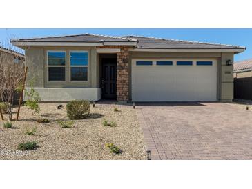 Charming single-story home featuring brick accents, a two-car garage and desert landscaping at 11744 S 173Rd Ln, Goodyear, AZ 85338